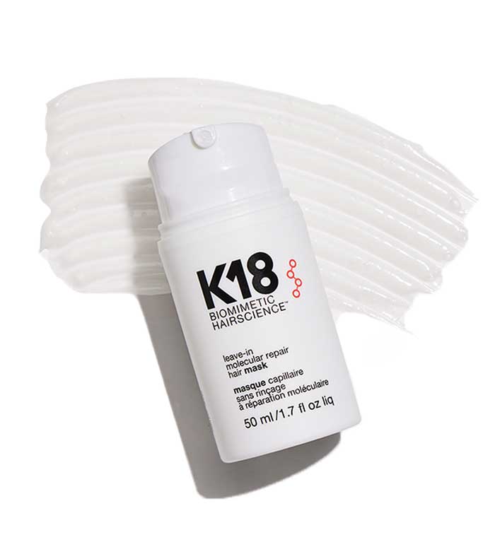 K18 hair mask bottle on textured cream background.
